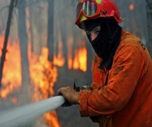 Fireman or firefighter in action with the fire hose extinguishing a fire puzzle