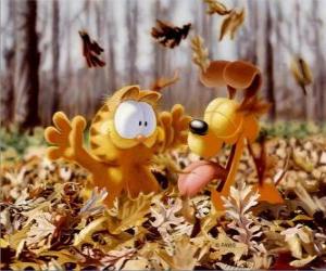 Garfield and Odie playing with fallen leaves in autumn puzzle