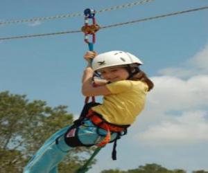 Adventurous girl jumping with a rope and harness puzzle