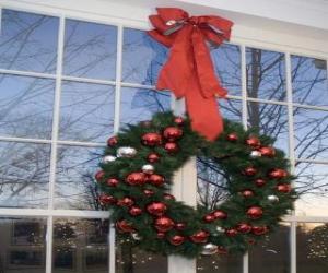 Big Christmas wreath decorated with a large ribbon and baubles puzzle