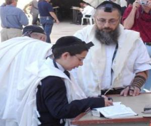 Boy studying with his teacher, both with Kippah, ritual small skullcap puzzle