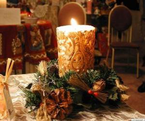 Candle ignited as a centerpiece adorned with sprigs of holly and fir puzzle