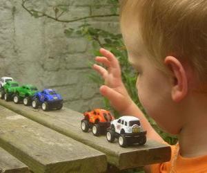 Children playing with toy cars puzzle