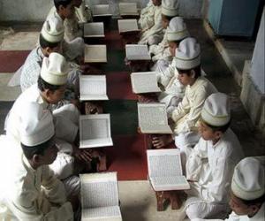 Children reading the Qur'an, Quran, or Koran, the sacred book of Islam puzzle