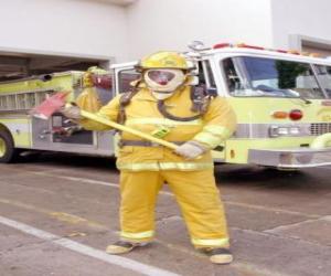 Fireman fully equipped with the ax in his hand against the truck puzzle