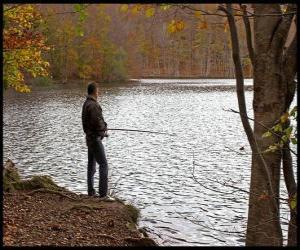 Fishing - Fisherman in river action in a forested landscape puzzle