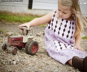 Girl playing with a tractor puzzle