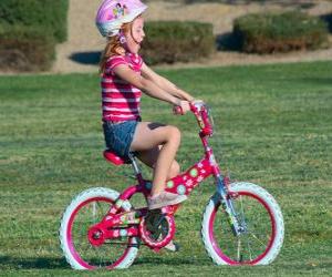 Girl riding a bicycle in the park in spring puzzle