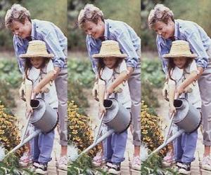 Grandmother teaching her granddaughter to irrigate puzzle