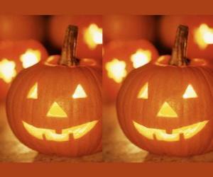 Halloween pumpkins carved with a face and a lit candle inside or Jack O'Lantern puzzle
