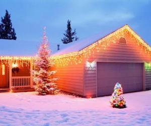 House decorated with Christmas decorations and two Christmas trees in the garden puzzle