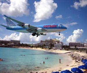 Landing airplane passing over the beach puzzle