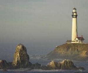 Lighthouse and lighthouse keeper's house, a tower with a powerful lamp on the top next to the coast for navigation of vessels puzzle