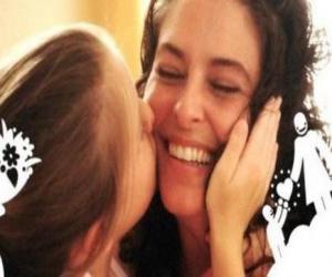 Mom or mother kisses her daughter to receive puzzle