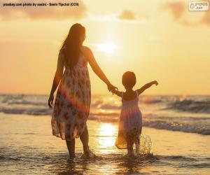 Mother with her daughter on the beach puzzle