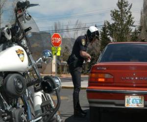 Motorized police officer with his motorcycle and put a fine on a driver puzzle