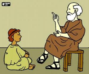 Professor or teacher, sitting on a stool, to teach a young boy, sitting on the floor puzzle
