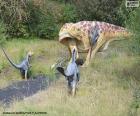 Dinosaur roaring in the face of attack by three other smaller dinosaurs