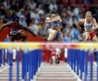 Hurdling, athlet crossing over the hurdle barrier