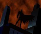 Batman watching the city from the roof of a building in Gotham City