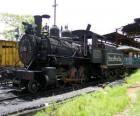 A train steam parked at the station