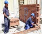 A bricklayer raising a wall