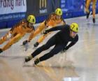 Three skaters in a speed skating race