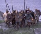 Vikings disembarking of his boat completely armed and with the shield and the lance in the hands