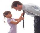 Dad watching his daughter as he knotted tie