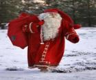 Santa Claus or Santa carrying a sack full of gifts