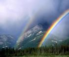 Landscape with rainbow, sun, clouds