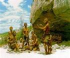 Group of men of Neanderthal under the protection of a rock shelter, the individuals realising different activities: chartting stones, others preparing the hunting