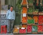 Seller of fruits and vegetables in his shop