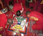 Three monks working on the elaboration of a mandala