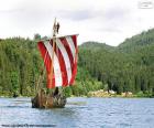 Drakkar or viking ship with all the rowers in action and the swollen sail with the wind