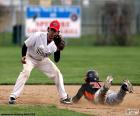 Baseball runner is pulled to the ground before getting to the base