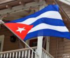 The flag of Cuba consists of five stripes horizontal where two are white and three are in color blue. On the left side of the flag, a red triangle and a White Star are. 1902
