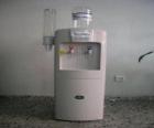 Cold water dispenser with water tank above the dispenser cups