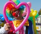 Clown with a pink heart shaped balloon