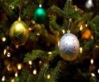 Three Christmas balls hanging from tree