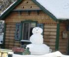 Snowman near a house