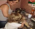 Grandmother teaching her granddaughter to cook
