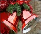 Christmas bells with a big bow and fir leaves