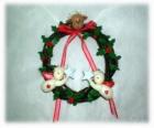 Christmas wreath decorated with holly leaves a head of a reindeer, two angels and a red bow