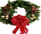 Christmas wreath decorated with a large ribbon and balls