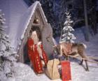 Santa at the door of his house with a reindeer and gifts