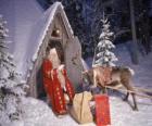 Santa at the door of his house with a reindeer and gifts