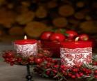 Christmas Candles lit and decorated with red berries