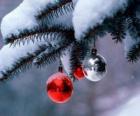 Three Christmas balls hanging from tree