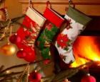 Christmas socks with decoration and hanging on the wall of the chimney
